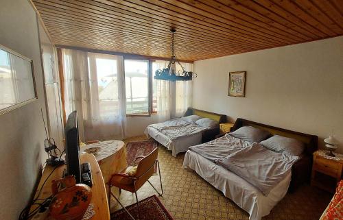 a living room with two beds and a couch at Fenyves Villa in Balatonakarattya
