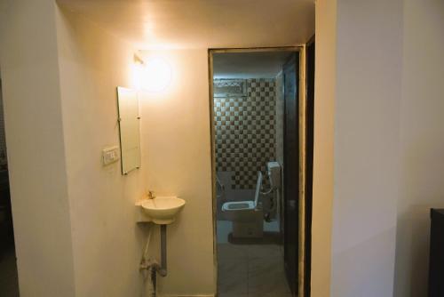 a bathroom with a sink and a toilet at Blue Beds Homestay, Exotic 2BHK AC House in Jabalpur