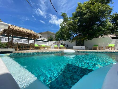 a swimming pool with blue water in front of a house at Crystal Bay Tropical Residence in Koh Samui 