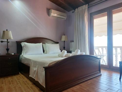 a bedroom with a bed with two towels on it at Saguaro’s home Kavala in Kavála