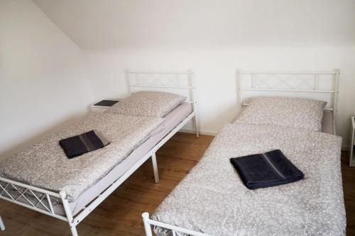 two twin beds in a room with two towels on them at Boardinghouse in Mörfelden-Walldorf in Mörfelden-Walldorf