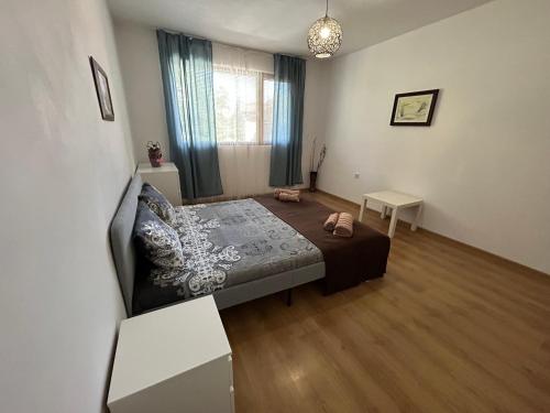 a bedroom with a bed and a couch in a room at АПАРТАМЕНТ МАЯ с две спални in Kazanlŭk