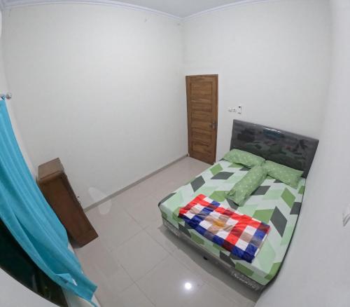 a bedroom with a bed in a room at Bovalia Homestay Jogja in Seturan