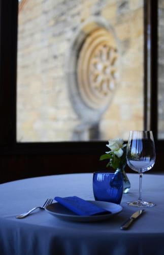 a table with a plate and a glass of wine at Santuario Virgen de la Fuente in Peñarroya de Tastavins