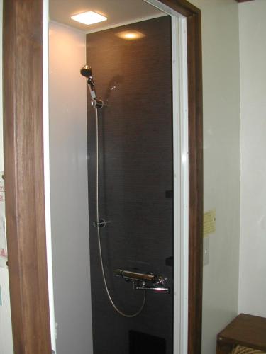 a shower with a glass door in a bathroom at Bistare Kana in Niseko