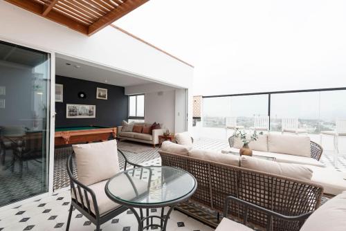 a living room with a couch and a table at Stunning Modern 1BD Apartment in Barranco in Lima