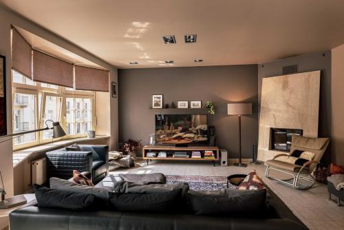 a living room with a couch and a fireplace at Spacious 2-story apt. w/ terrace - 280 m2 in Riga