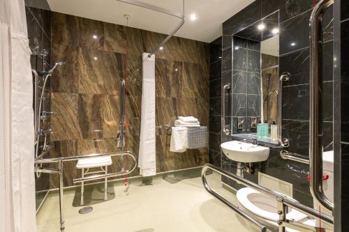 a bathroom with a shower and a sink at Keavan's Port Hotel , Dublin in Dublin