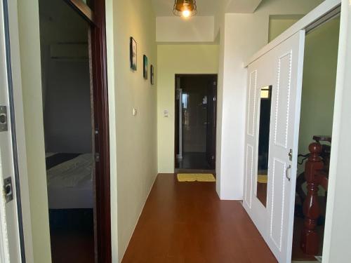 a hallway leading to a bedroom with a bed at Sea Princess B&B in Fengbin
