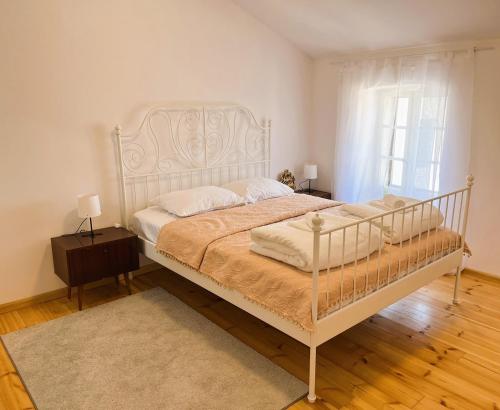 a bedroom with a white bed and a window at Zamaria Apartments in Vis
