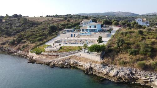 an aerial view of a house next to the water at Iris Villas in Spárton