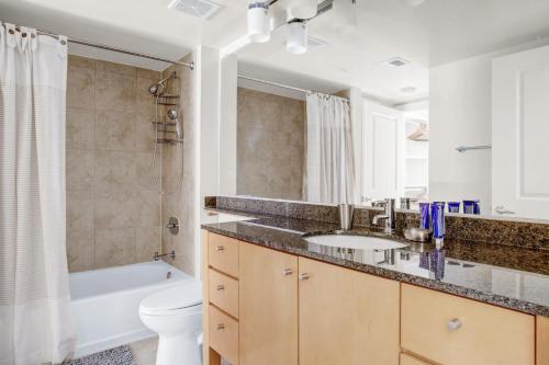 a bathroom with a sink and a tub and a toilet at Bethesda 1BR w Concierge Gym WD nr Metro WDC-333 in Bethesda