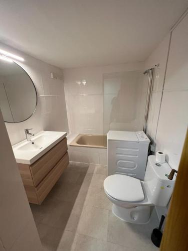 a bathroom with a toilet and a sink and a tub at Your Place Benasque in Benasque
