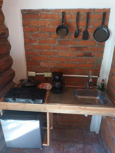 a kitchen counter with a stove and a sink at Parador Arew 1 La Energa Que Impulsa El Alma in Creel