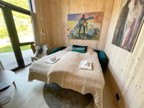 a bedroom with a bed in a wooden room at Atlantic Panorama Lofoten in Leknes