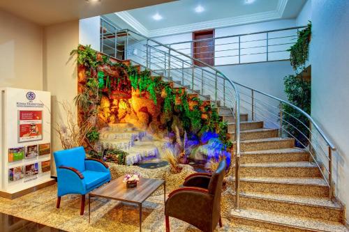 a wall mural of a staircase with a waterfall at Bera Konya Hotel in Konya