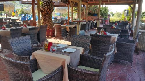 an outdoor dining area with tables and chairs at Sidari Waterpark in Sidari