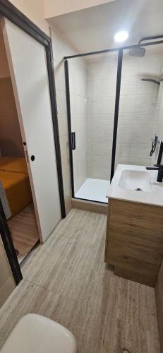 a bathroom with a toilet and a sink and a shower at La Poussinière in Aiguèze