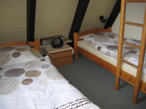 En eller flere senge i et værelse på Ferienhaus am Wald