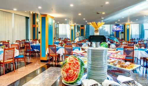 a restaurant with tables and chairs and plates on display at Bera Konya Hotel in Konya