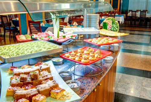 a buffet line with different types of cakes and pastries at Bera Konya Hotel in Konya