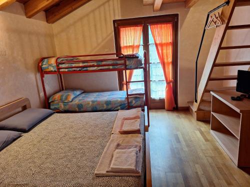 a room with two bunk beds and a staircase at Agriturismo La Ca' Vegia in San Cassiano