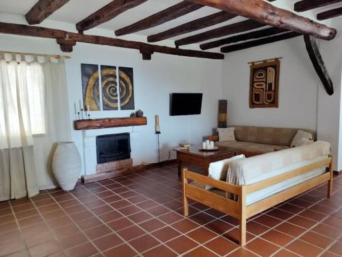 a living room with a couch and a fireplace at Casa Rural Las Adelfas in Cómpeta