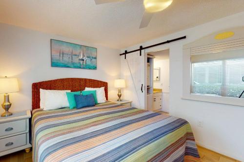 a bedroom with a large bed and a window at 380-D - Madeira Beach Yacht Club in St. Pete Beach
