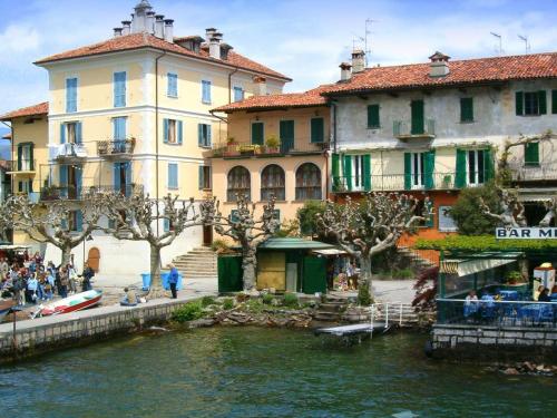 a group of buildings next to a body of water at Enticing Apartment in Stresa with Balcony Lake Views in Stresa