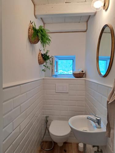 a white bathroom with a sink and a mirror at Apartment Archangelo St. Michael in Colonno