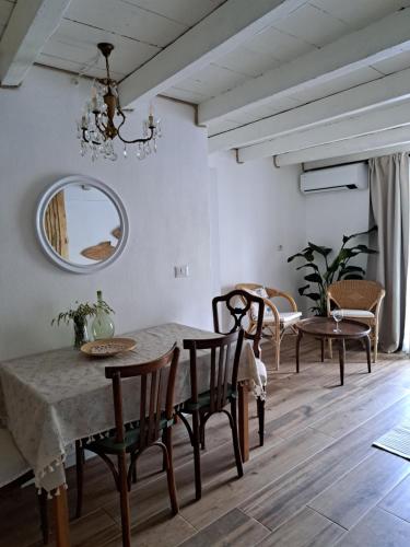 a dining room with a table and chairs and a mirror at Apartment Archangelo St. Michael in Colonno