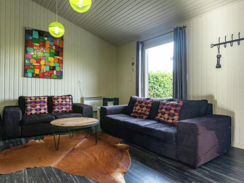 a living room with a couch and a table at Boutique Chalet in B llingen Near Lake in Wirtzfeld