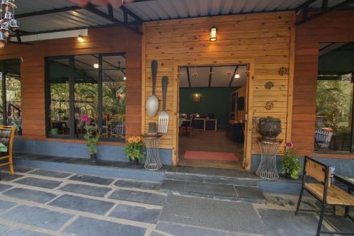a porch of a house with the door open at Pench Wilderness Camp Resort in Khawāsa