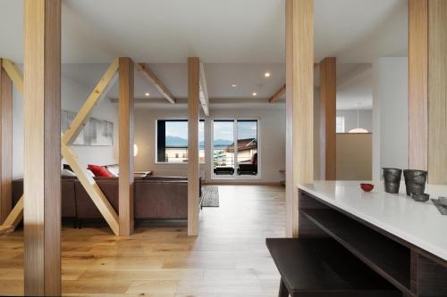 a kitchen and living room with a tub in a house at AKATSUKI in Furano