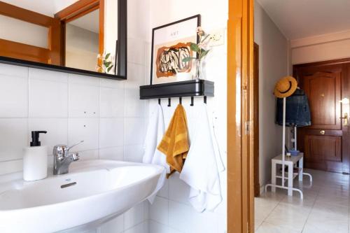 a bathroom with a sink and a mirror at VibesCoruna - Outeiro 222 in A Coruña