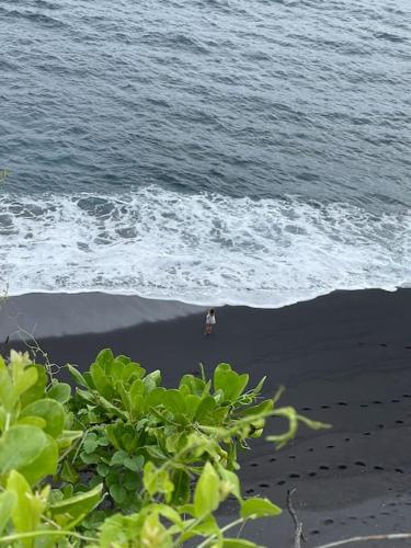 a person walking on the beach near the ocean at Makawi Tuwa in Seraya