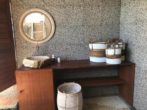 a bathroom with a vanity with a mirror and a sink at Makawi Tuwa in Seraya