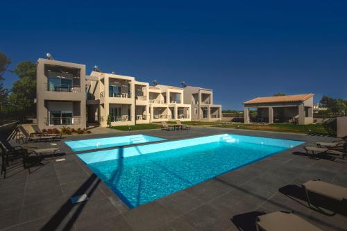 a large swimming pool in front of a house at Apanemo Kourouta Luxury Villas in Kourouta