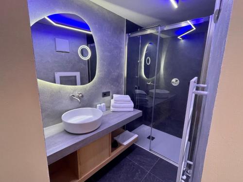 a bathroom with a sink and a shower at Hotel Des Alpes in Selva di Val Gardena