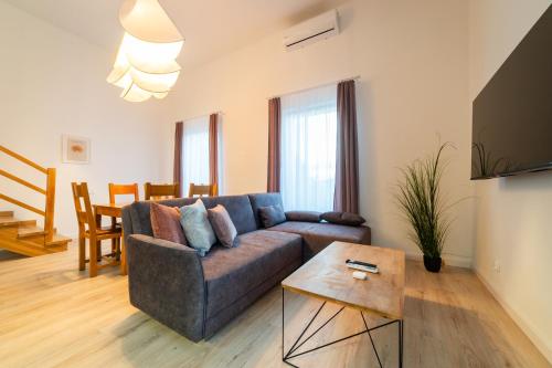 a living room with a couch and a table at Apartamenty Prusa in Mikołajki