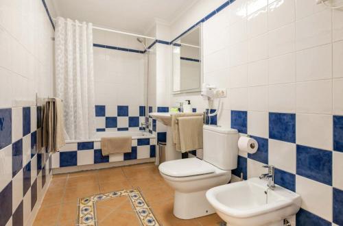 a blue and white bathroom with a toilet and a sink at Sunny Maria Apartment La Tejita Beach in Granadilla de Abona