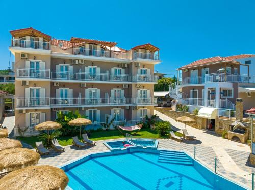 an apartment with a swimming pool and a building at Amoudi Studios Apartments Hotel in Amoudi