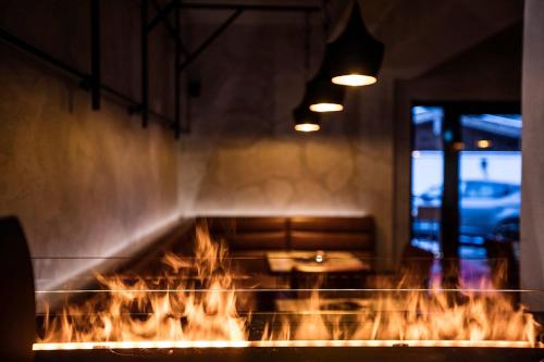 a grill with a table and fire in a room at Hotel Gasthof Perauer in Mayrhofen