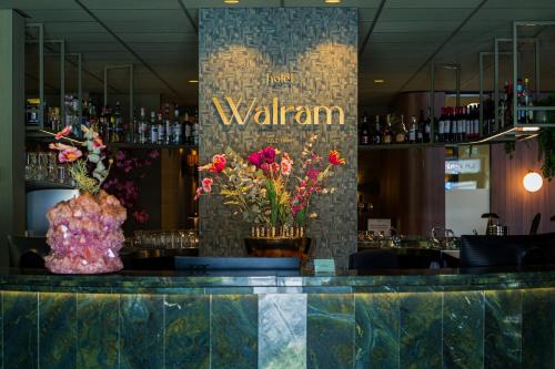 a bar with flowers on top of a counter at Hotel Walram in Valkenburg