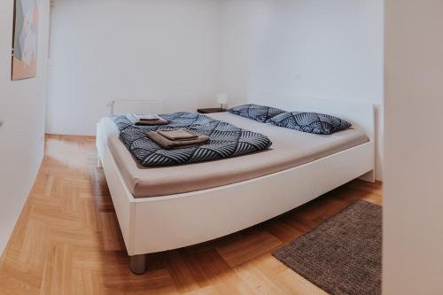 a bed sitting in a room with at Z'Argette Apartment - Free Parking @ Zagrebacka C. in Zagreb