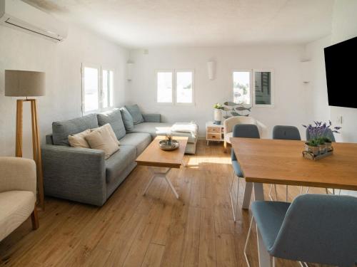 a living room with a couch and a table at Authentic apartment in Binibeca Vell with private terrace in Binibeca