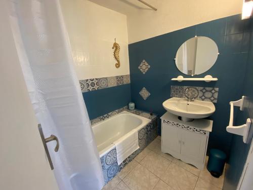 a bathroom with a tub and a sink and a mirror at Os-thel, Chambres à louer in Tautavel