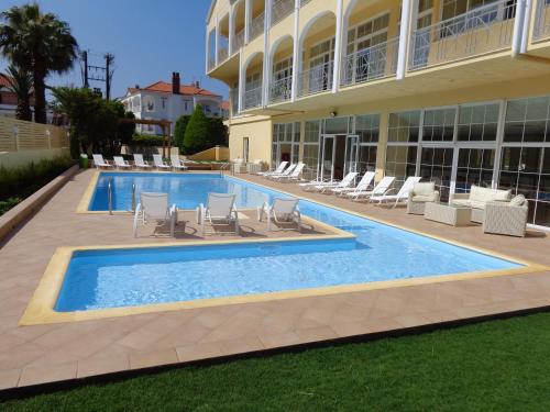a swimming pool in front of a building at Hotel Diamantidis in Myrina
