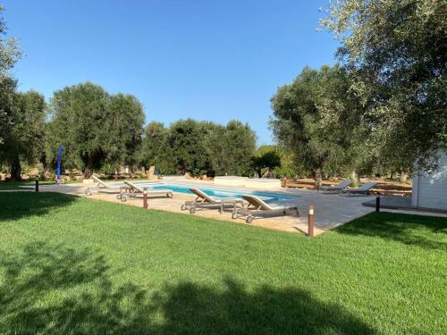 a pool with a bunch of slides in a park at Trullo Rosa del Sud-Benessere SPA in Ceglie Messapica