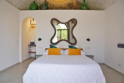 a bedroom with a bed with a mirror on the wall at Villa Pasquale Capri in Capri